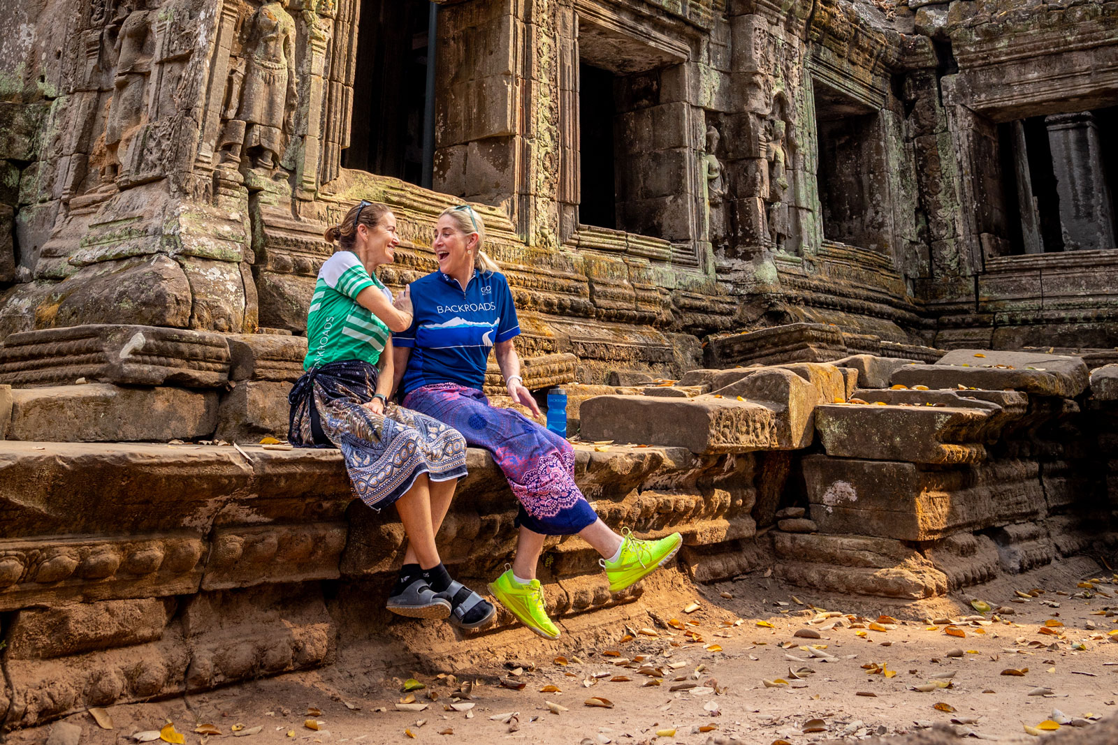 Two Backroads guests sit by a temple