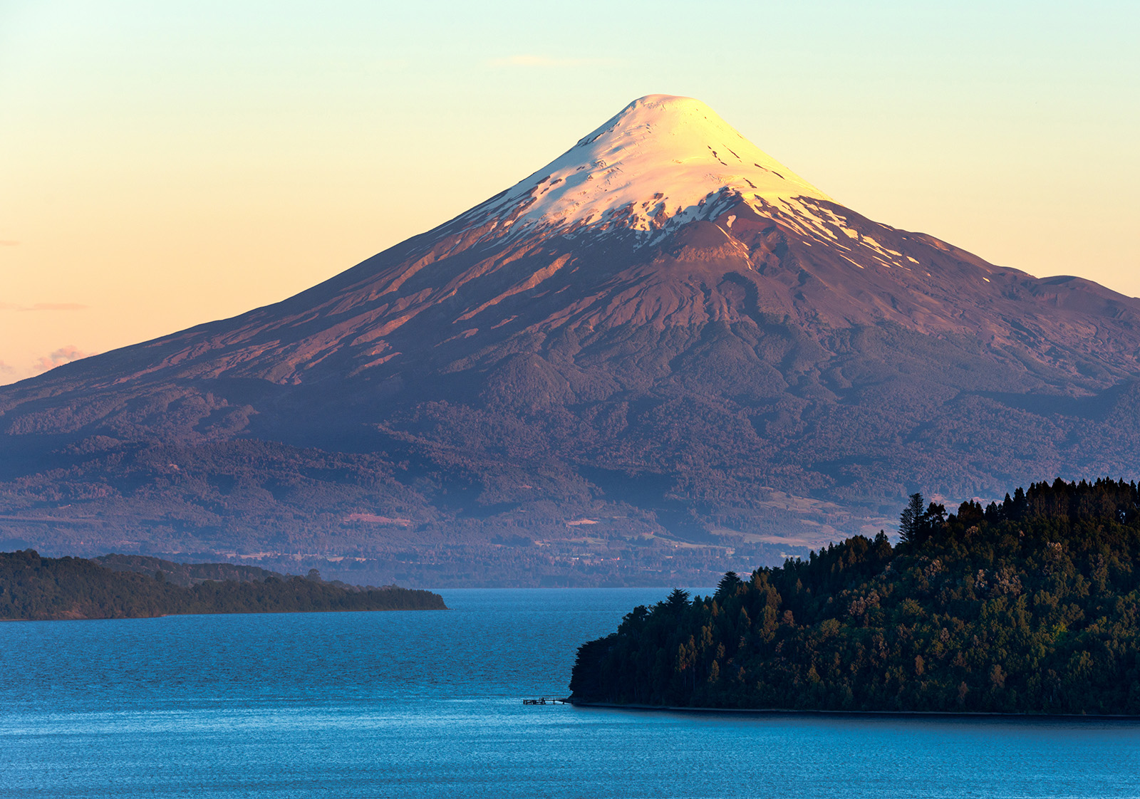 Snow-capped Chilean peak behind a large lake