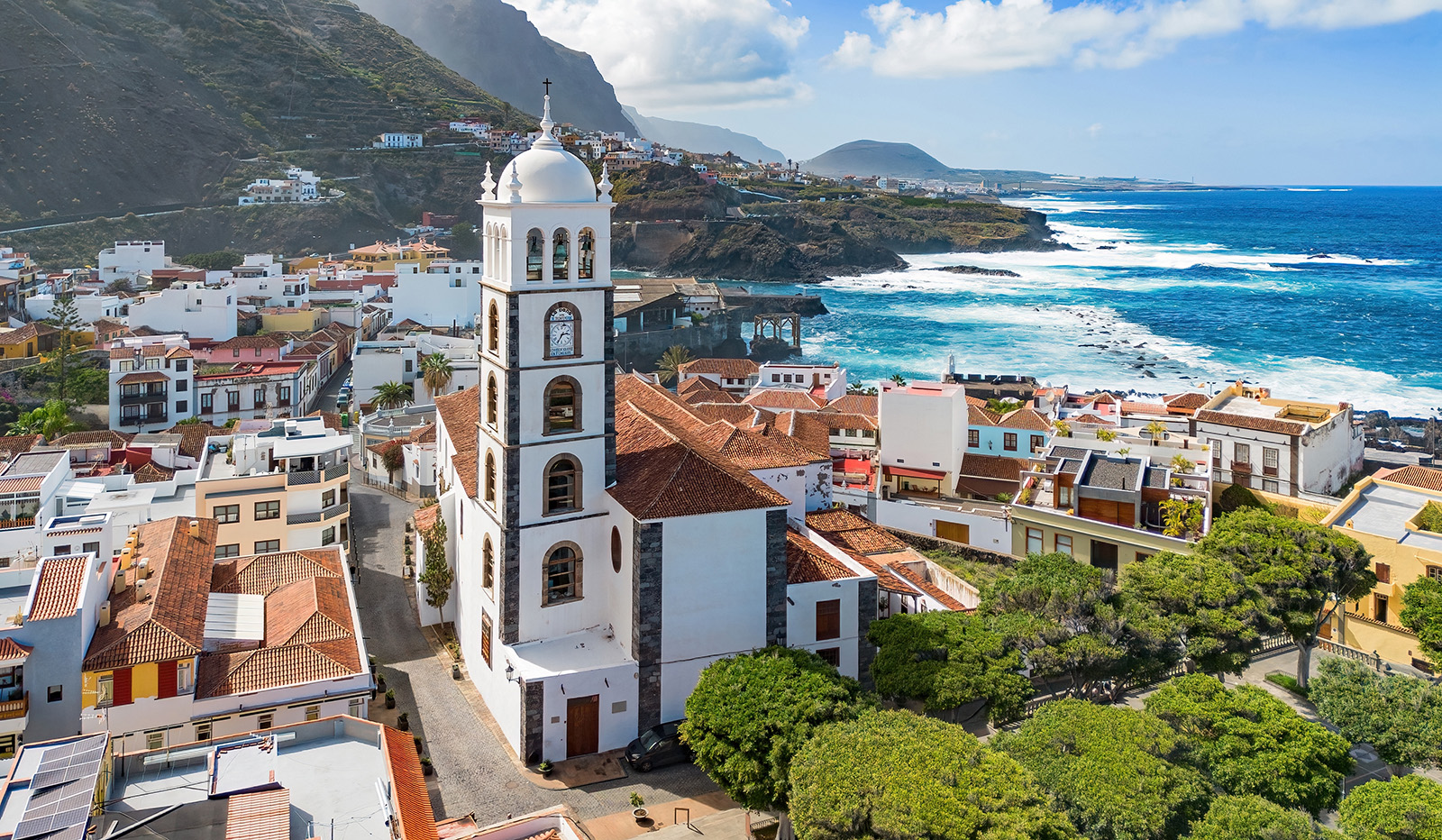 Town full of white and brown buildings with a church bell tower in the center