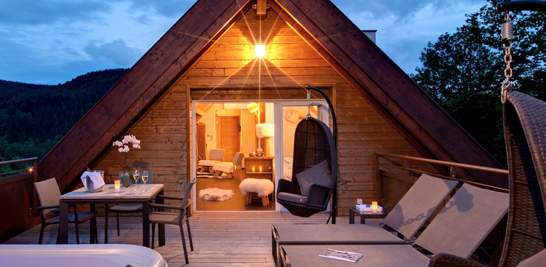 Outdoor patio with a hanging chair and dim light