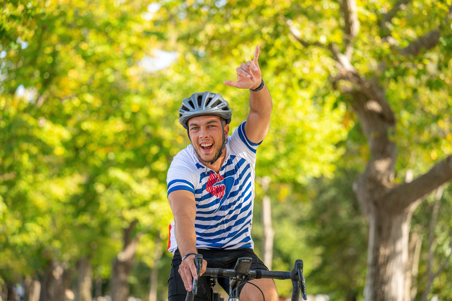 Man smiling while riding a bike
