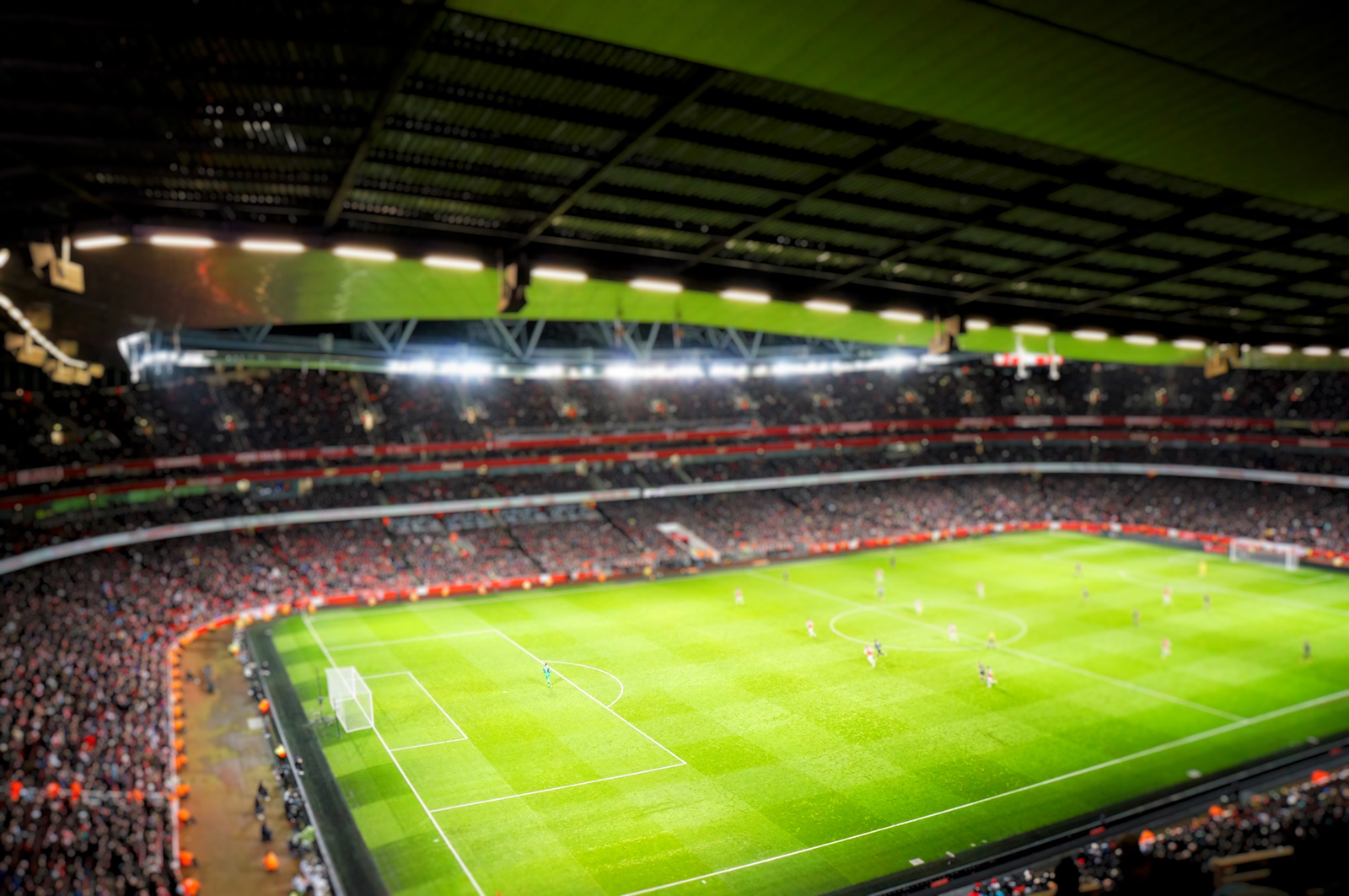 Wide view of a soccer stadium with people playing soccer