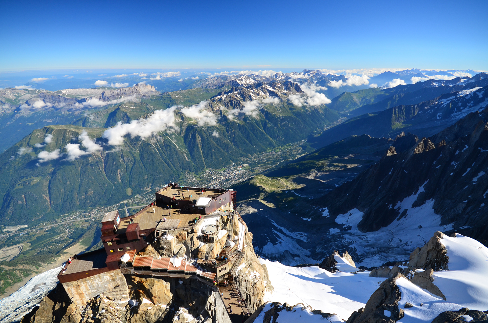 Drone shot of a summit house on snow-capped mountains