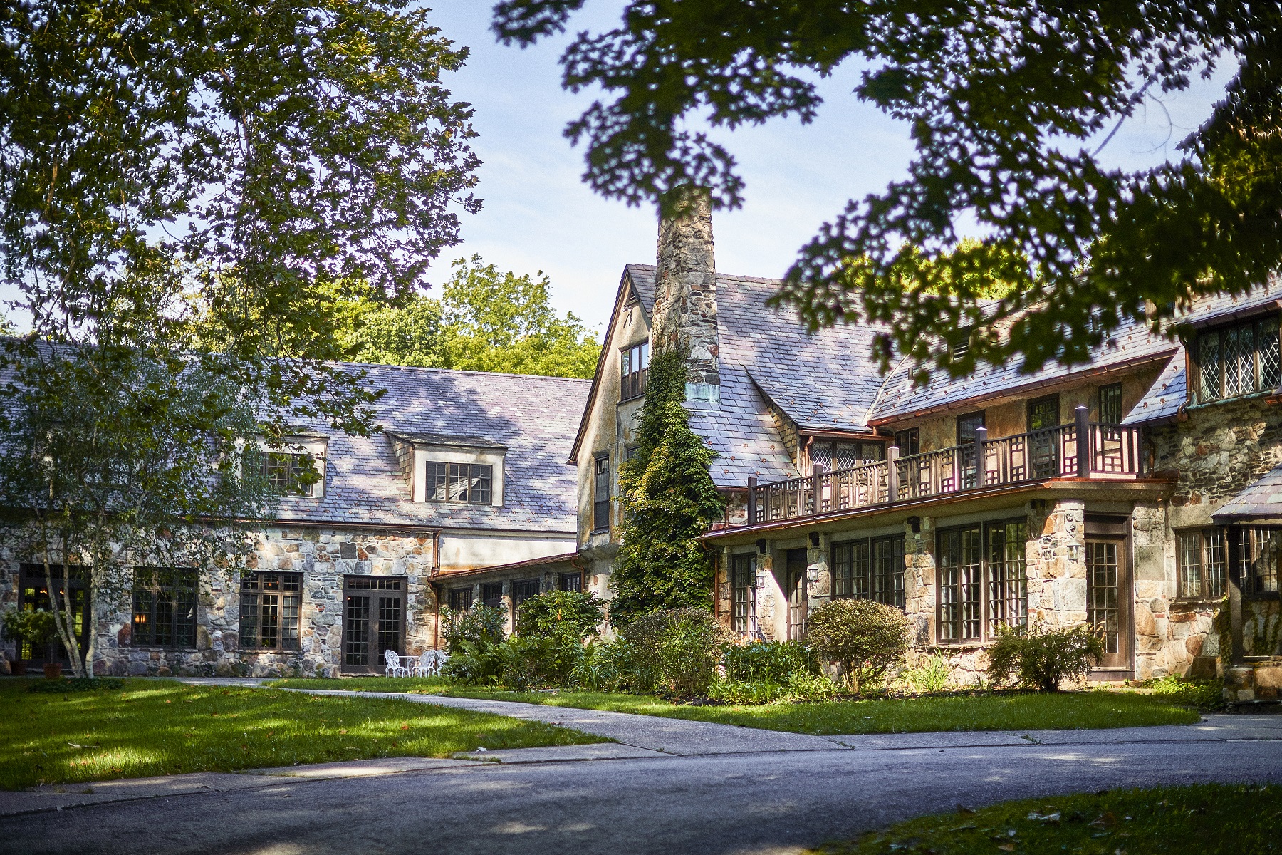 Stone building with large trees in front