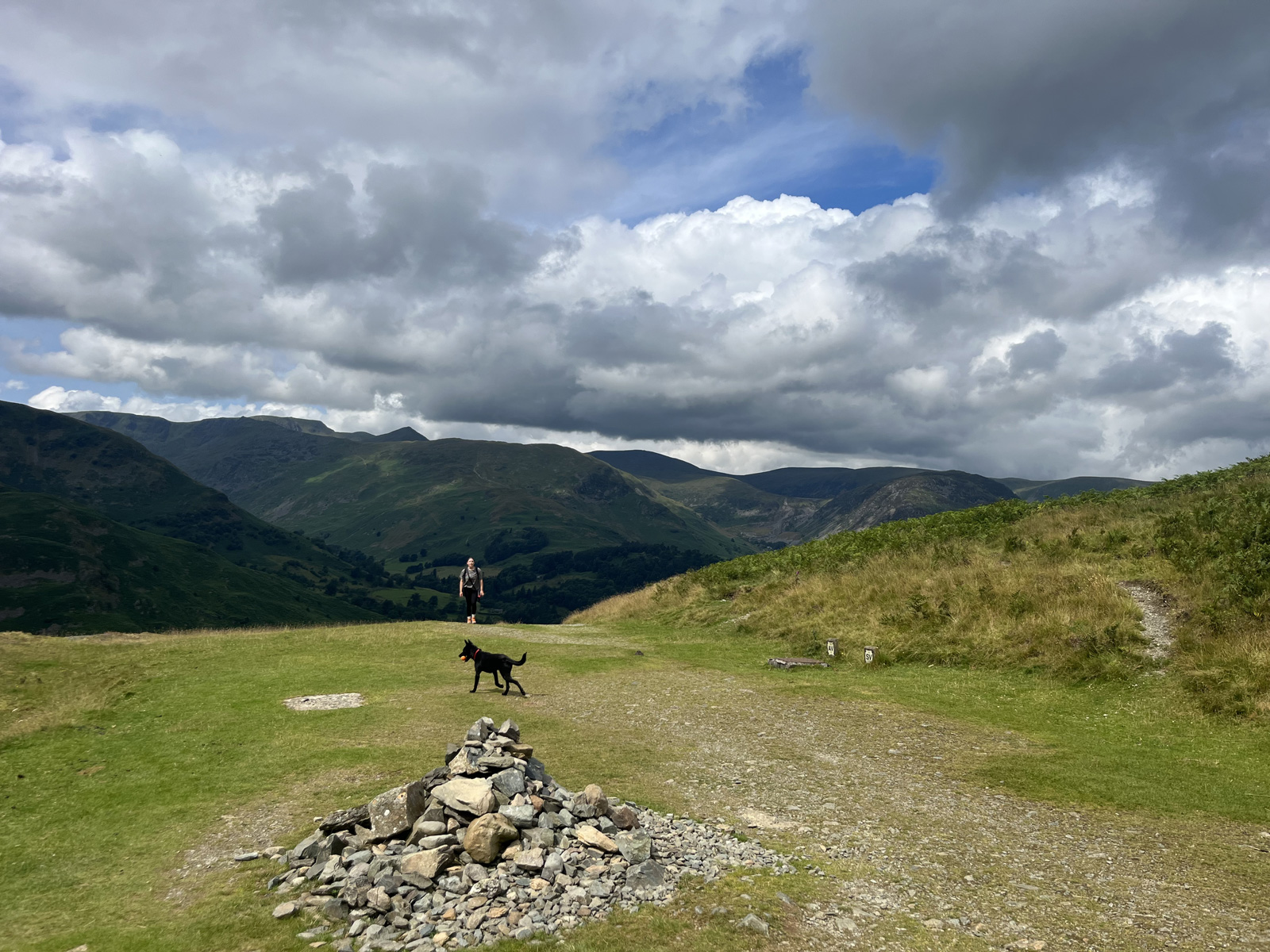 Gravel trail with mountains and clouds in the distance
