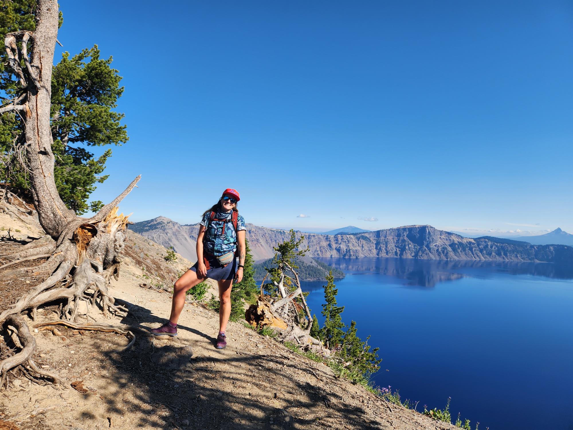 Woman standing on a hill with a lake to the right
