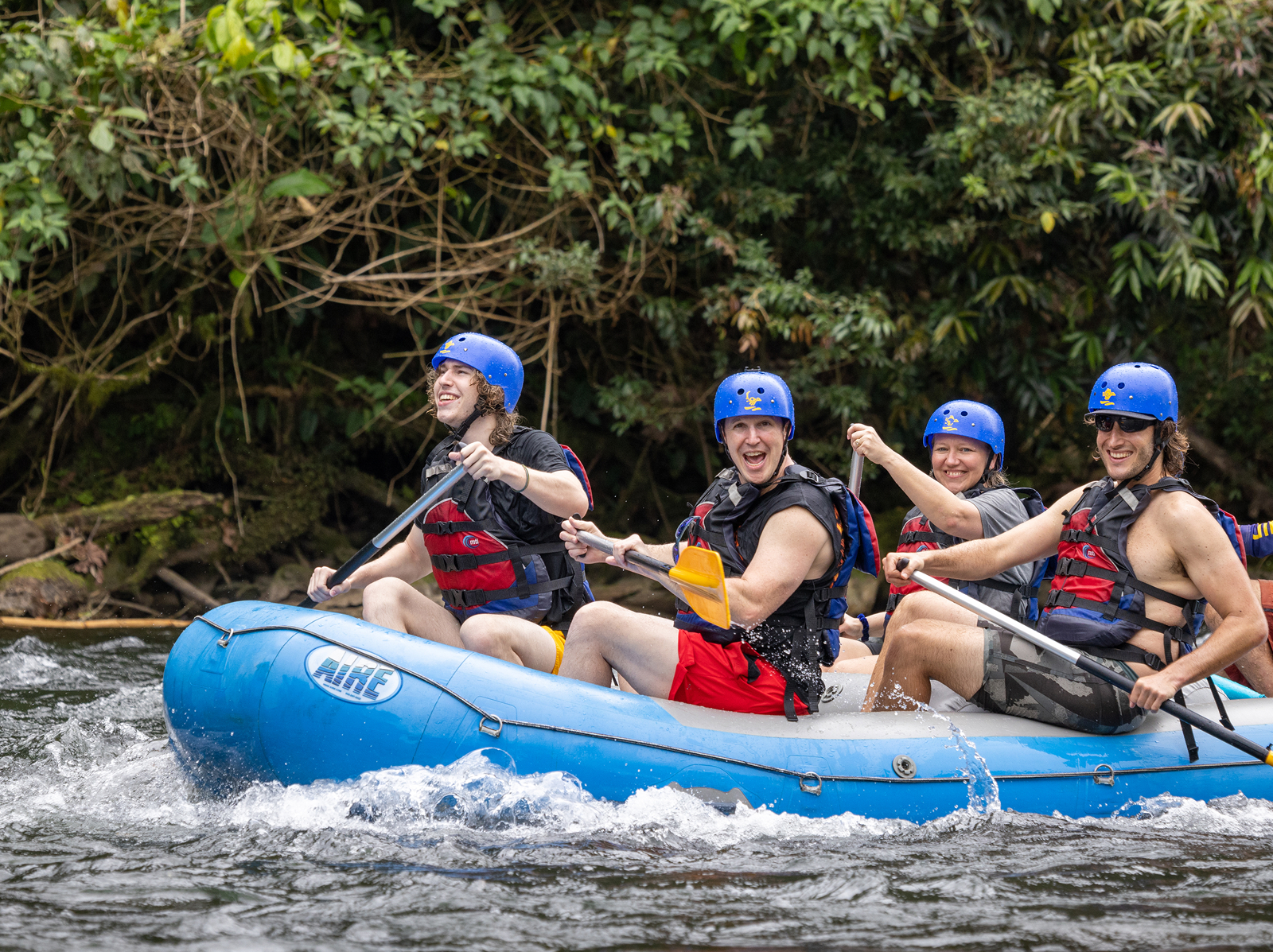 Three Backroads guests whitewater rafting