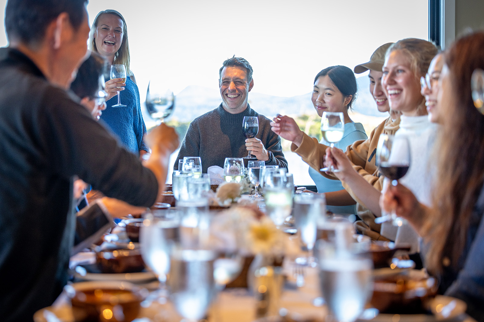 Backroads guests gather celebrate around a dinner table