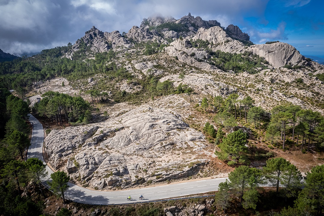 Large canyon and cliff with bikers on the road