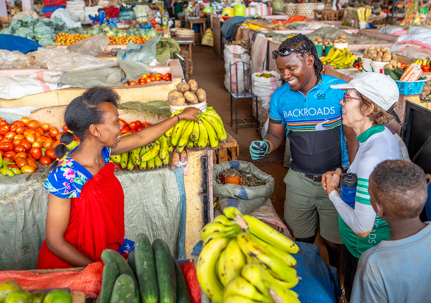Man and woman talking to a vendor at a fruit stall