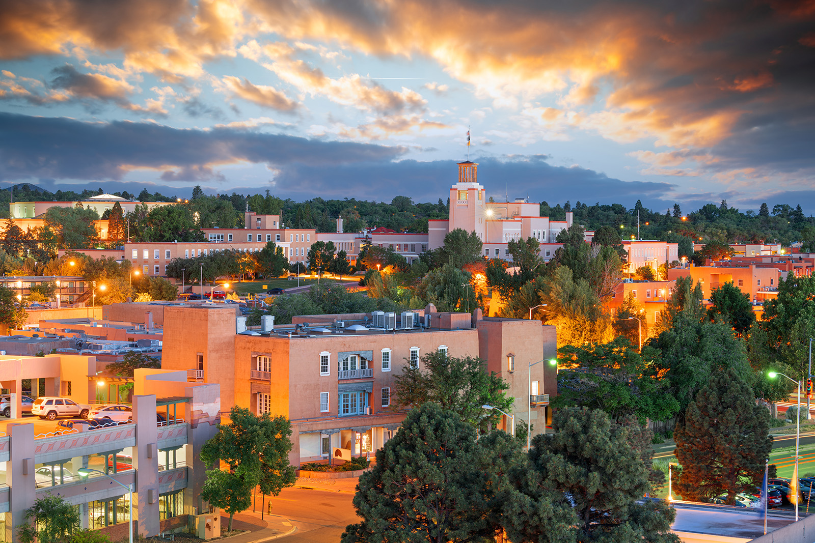 Town with building illuminated by orange lights