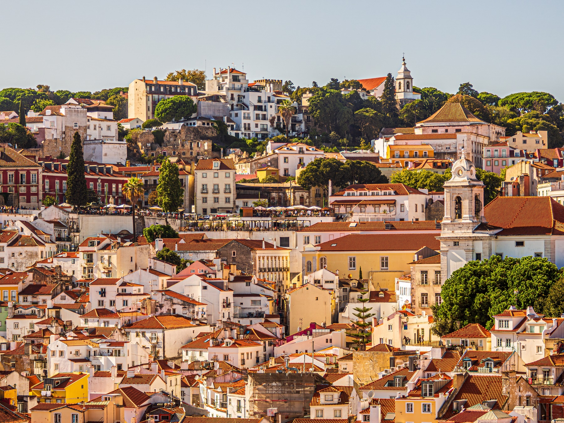 Town on a hill with beige and white houses and trees