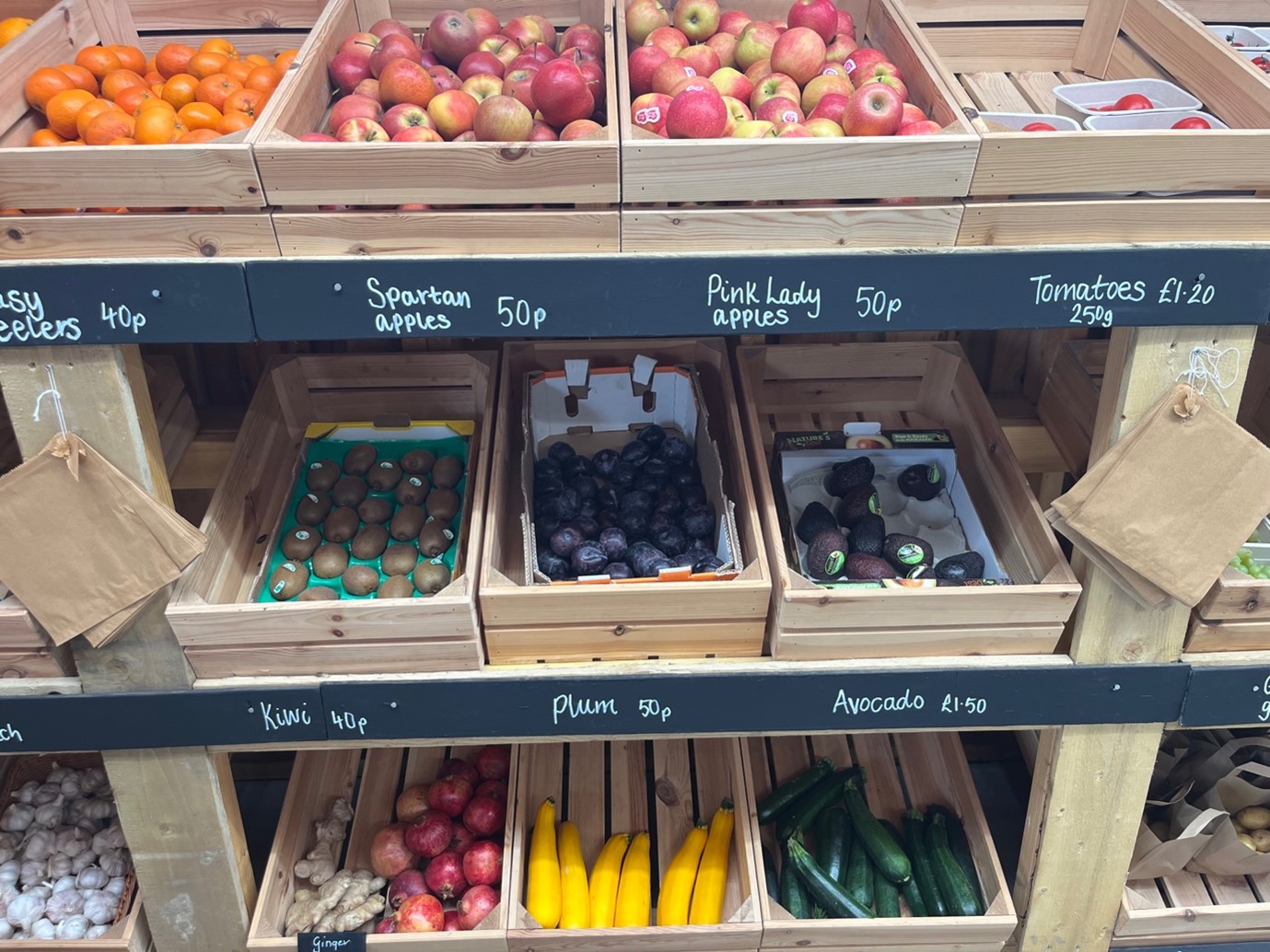 Wooden crates full of fruits and vegetables at a produce stand