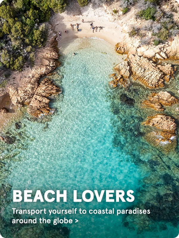 Beach with a sandy shore and tall boulders