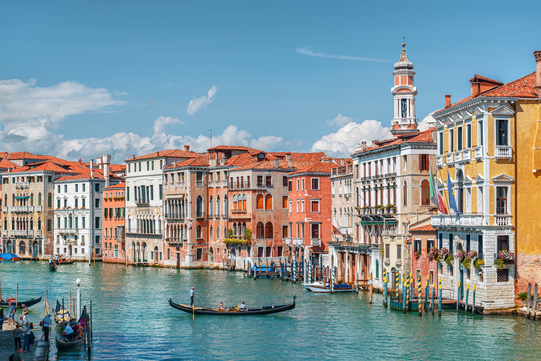 Italian town next to a river canal with floating boats