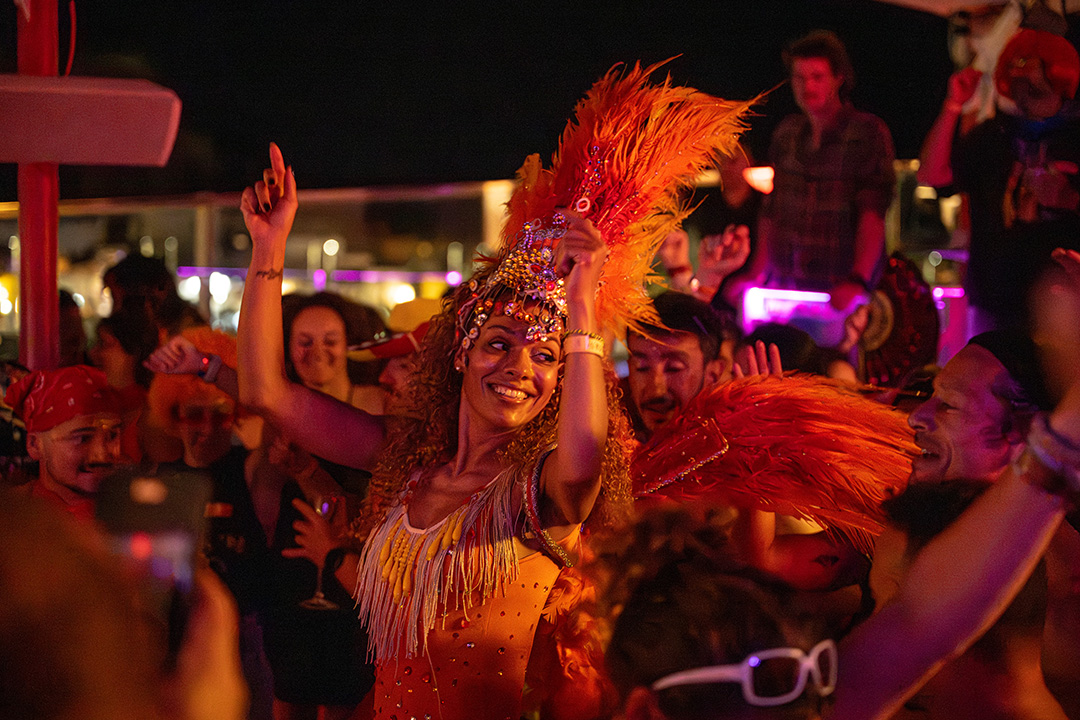 Woman dancing in the middle of a group of people