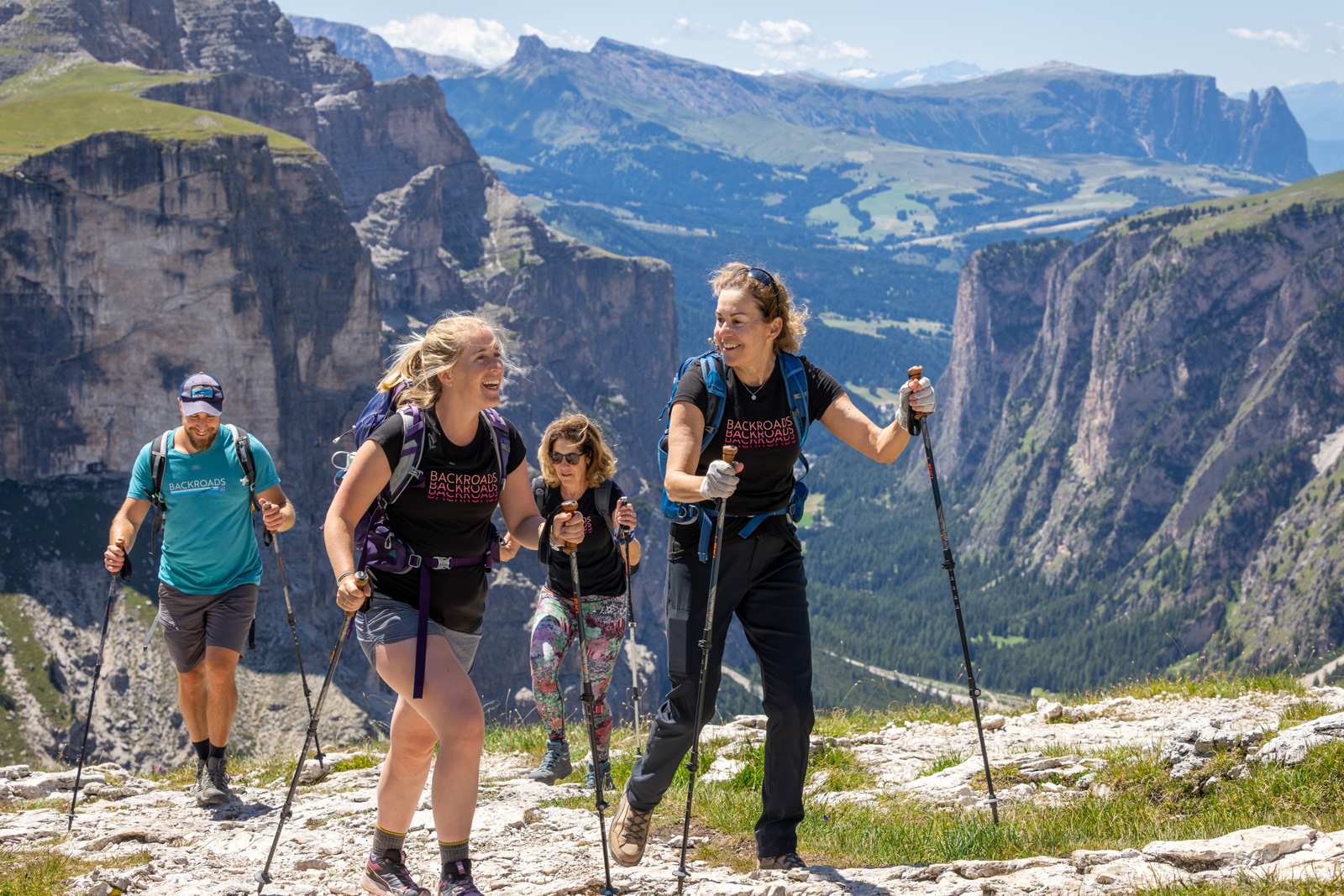 Group of women hiking on a gravel trail on a mountain