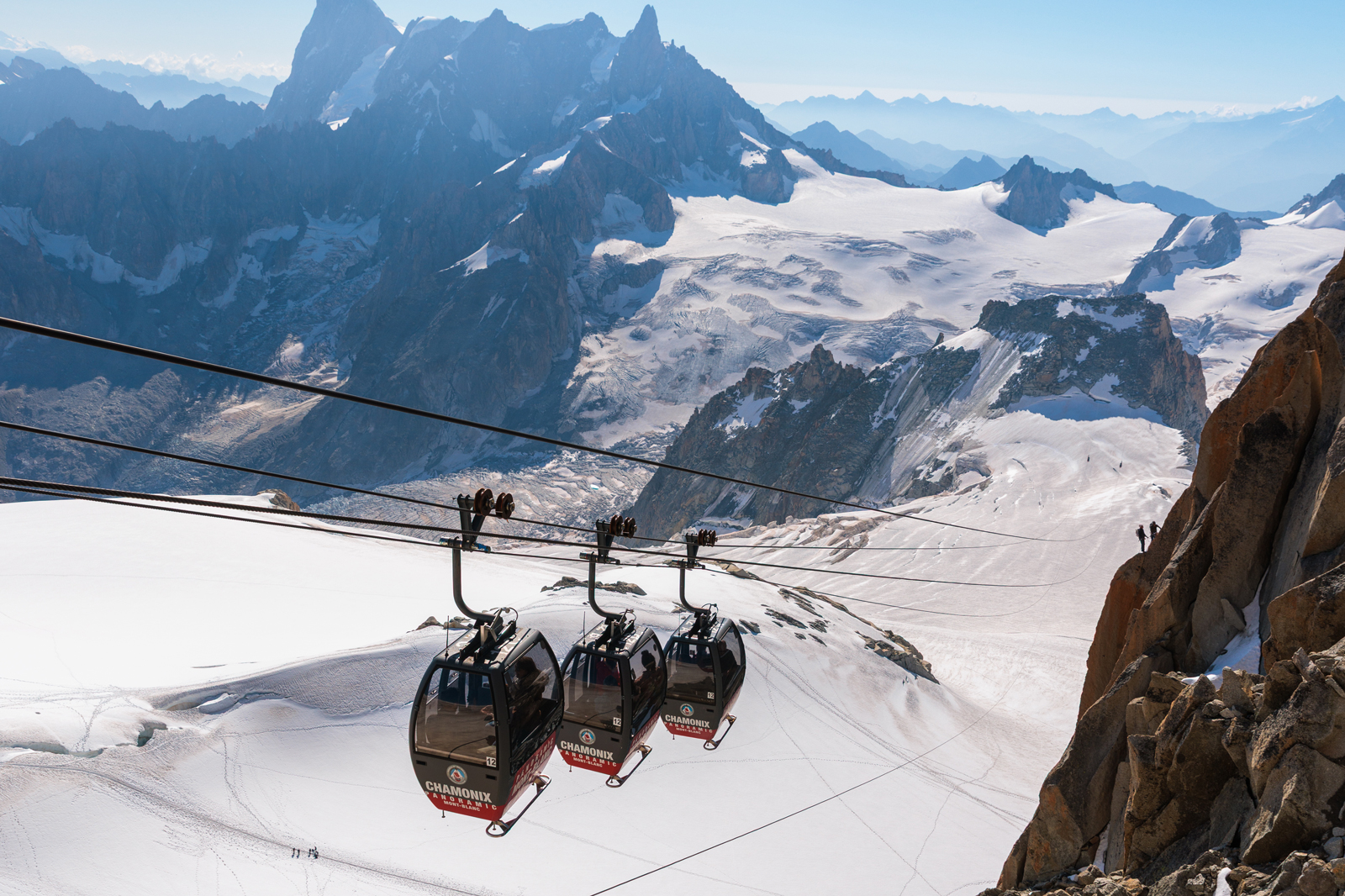 Gondola over snowy mountains