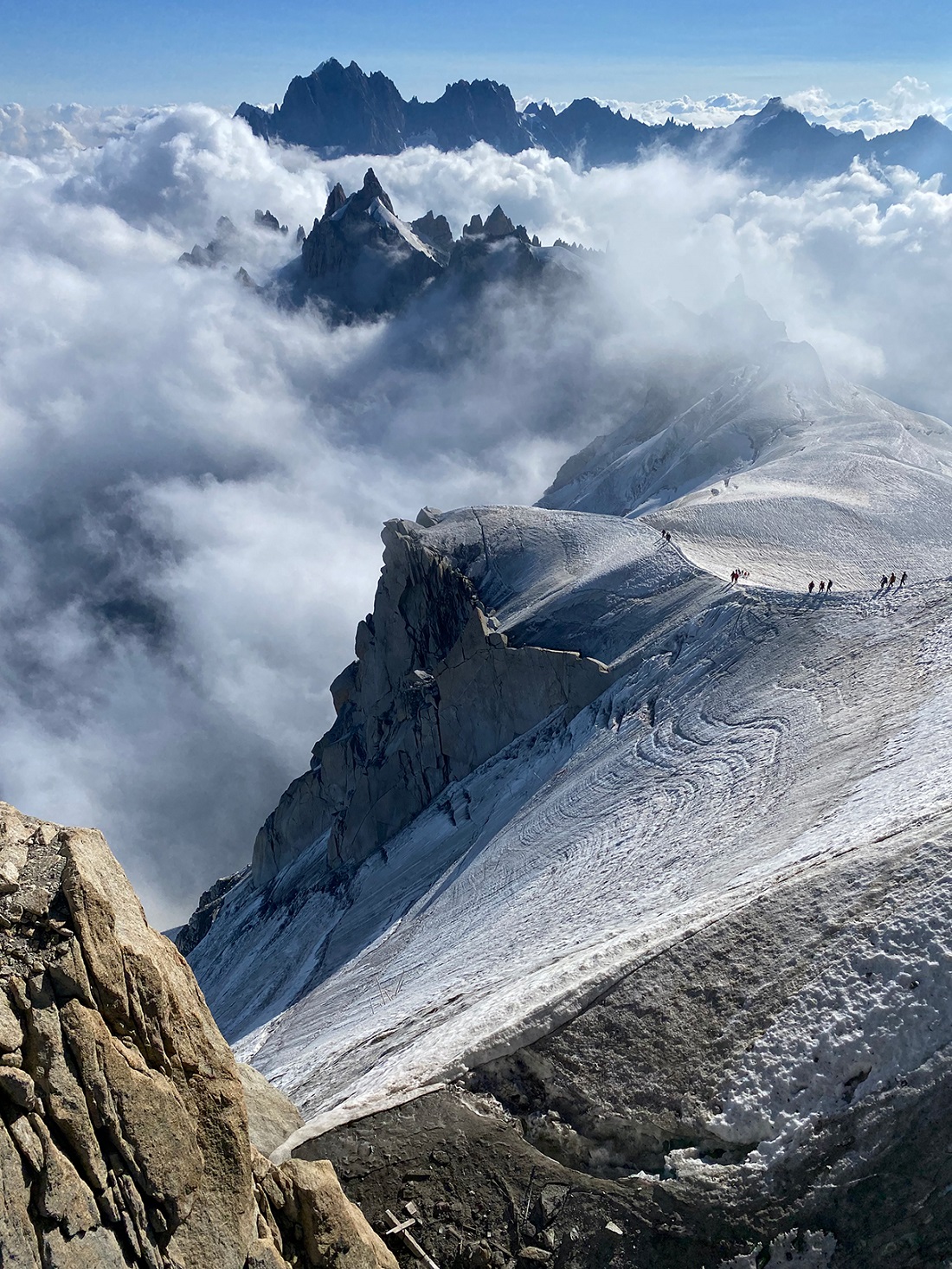 Large mountains surrounded by foggy clouds
