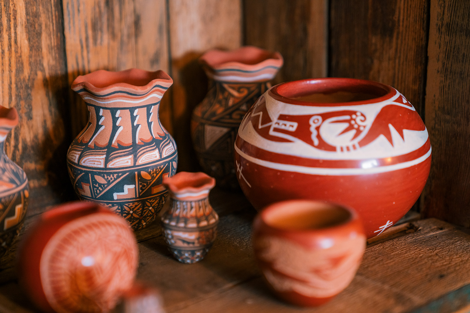 Clay, orange pots with art drawn on them