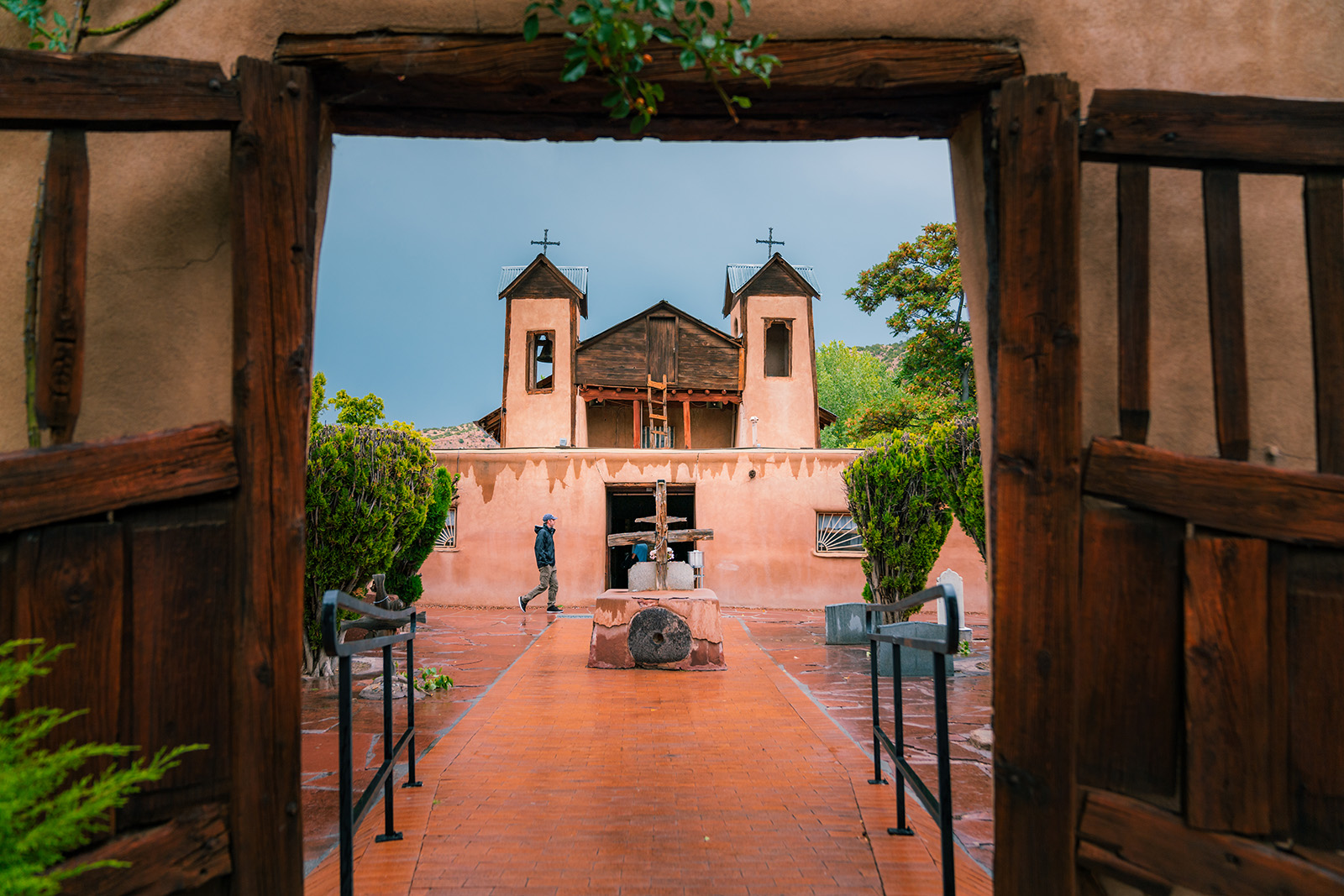 Open doorway leading out to a courtyard with a clay church building