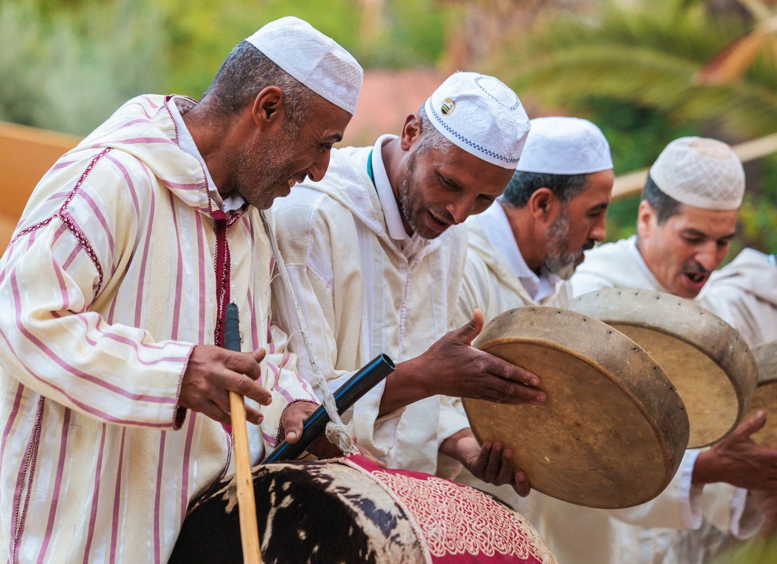 Group of men playing drum-like instruments