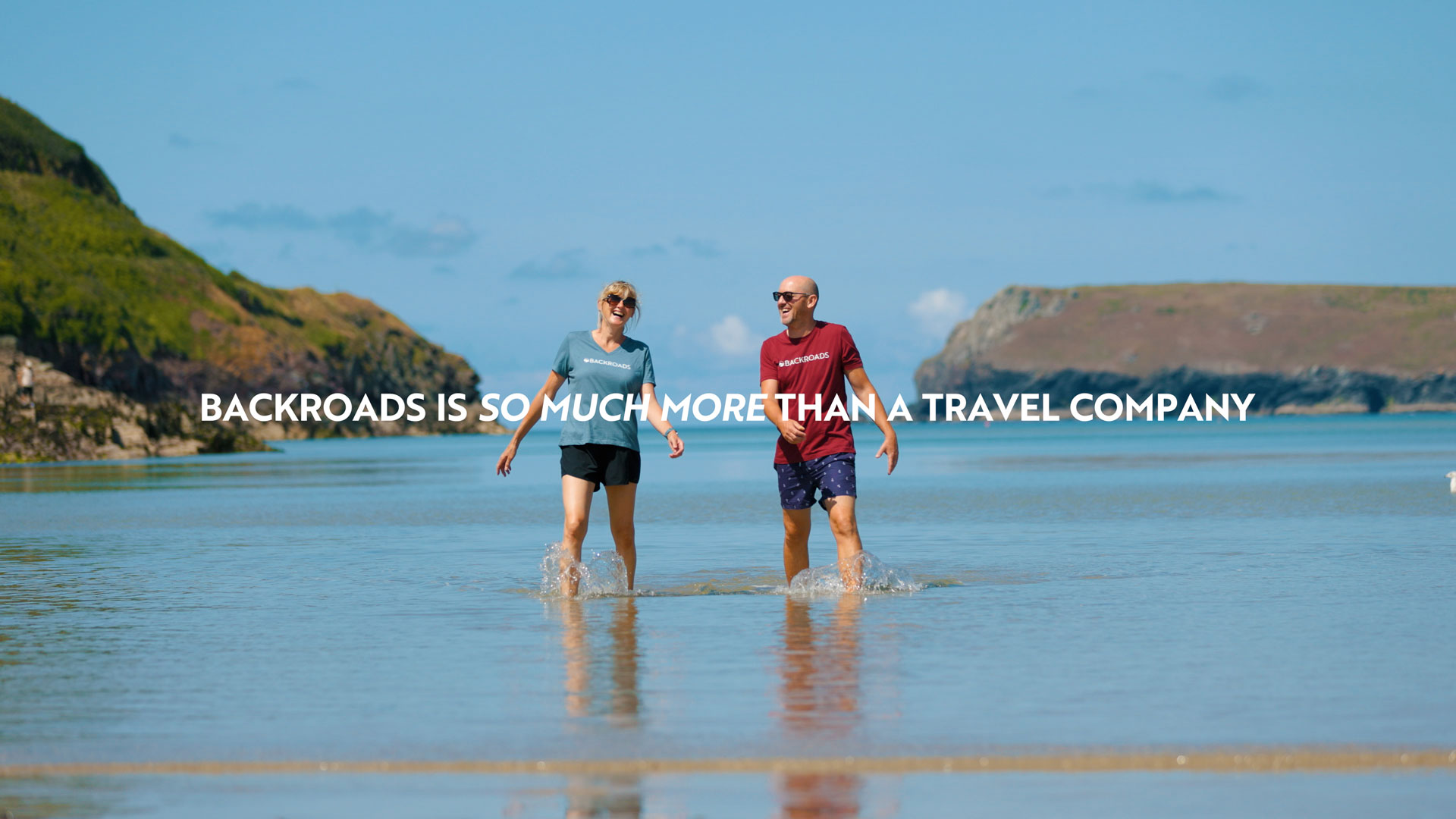 Two people walking on the beach