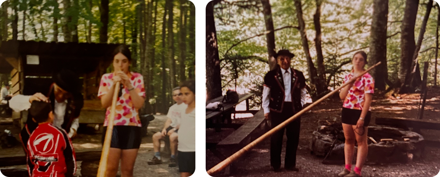 Girl blowing into a long horn instrument