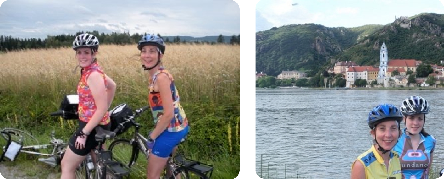 Two girls riding bikes in the middle of a valley