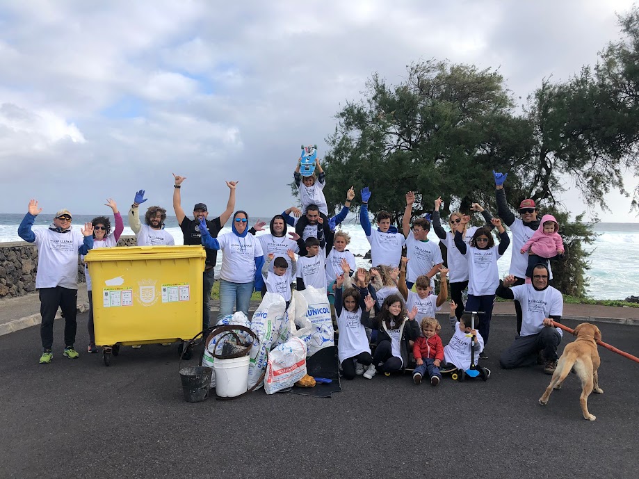 Group of people holding signs and smiling