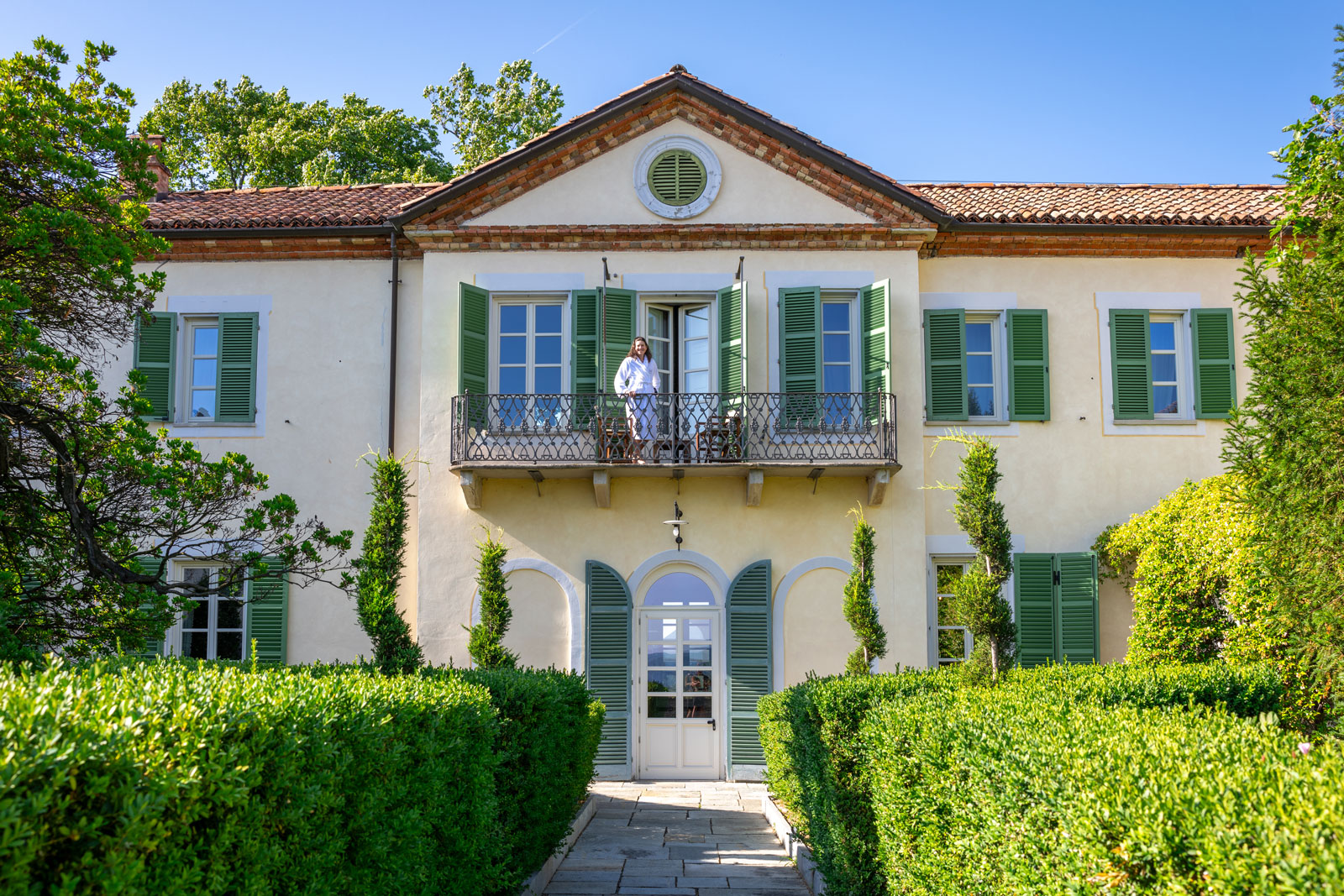 Woman standing on a balcony of a hotel room