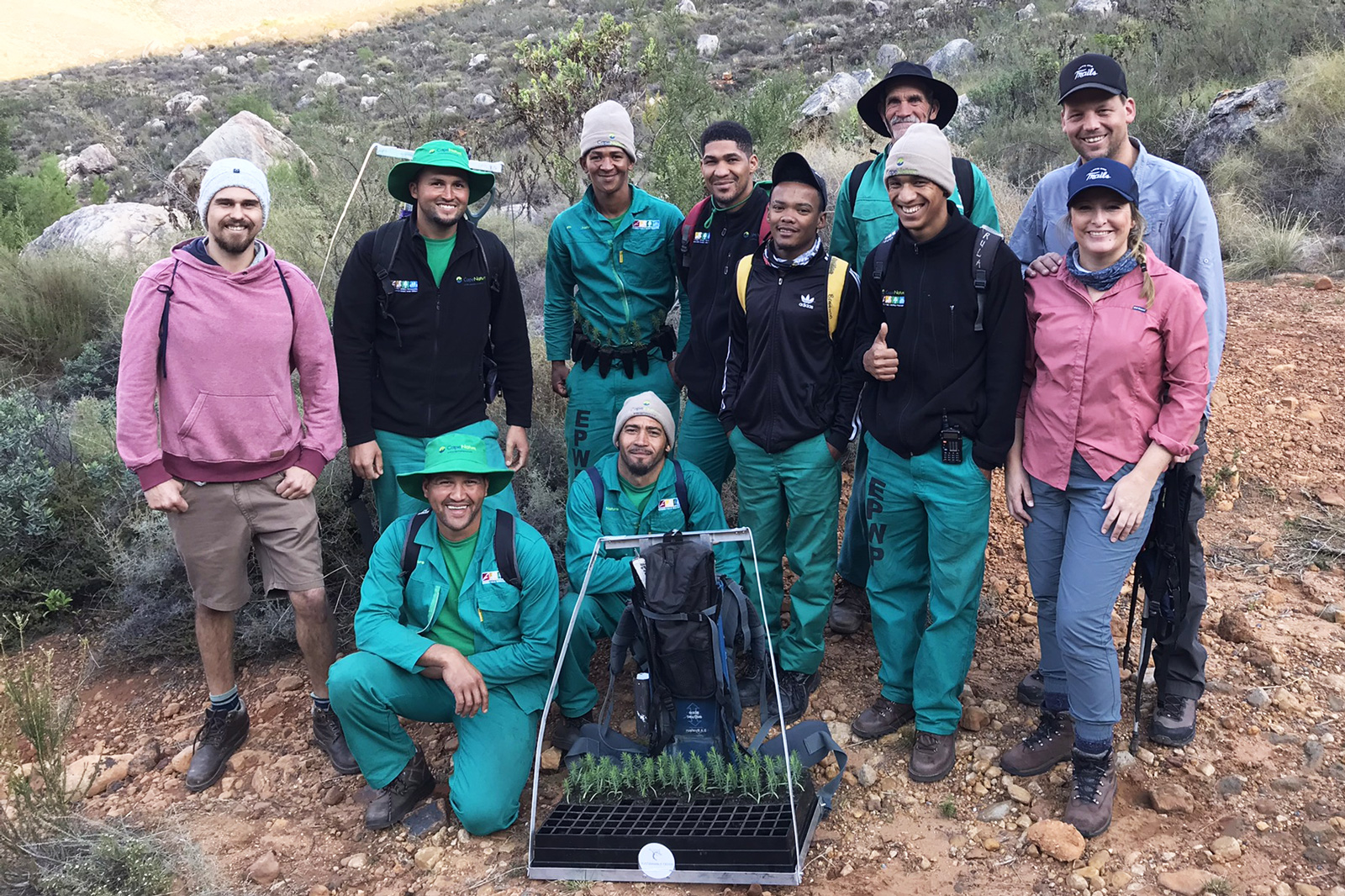 Group of people smiling, in the desert