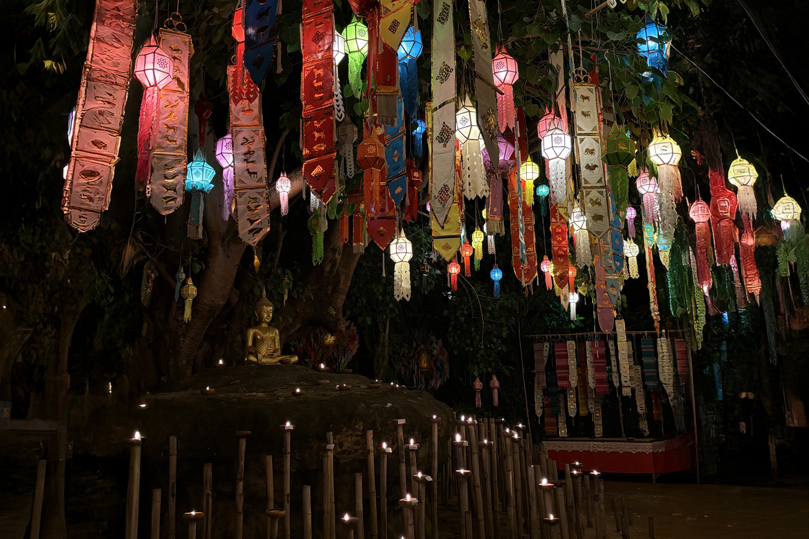 Asian temple and shrine with colorful decorations hanging from a rope