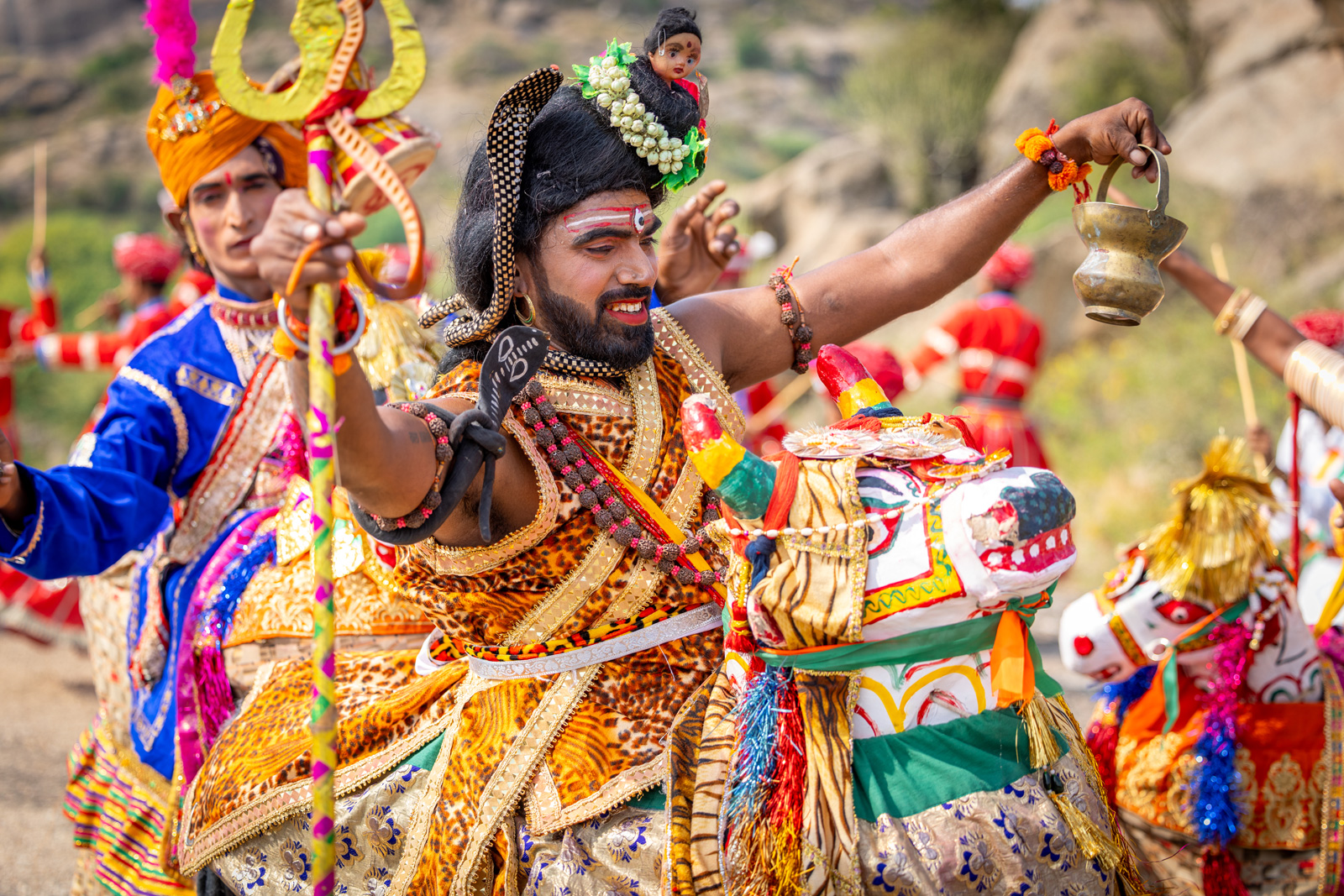 Man in traditional Indian clothing, smiling and dancing