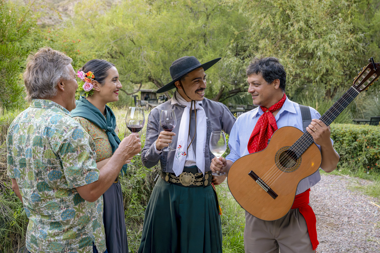 Man and woman smiling while listening to two men playing guitar