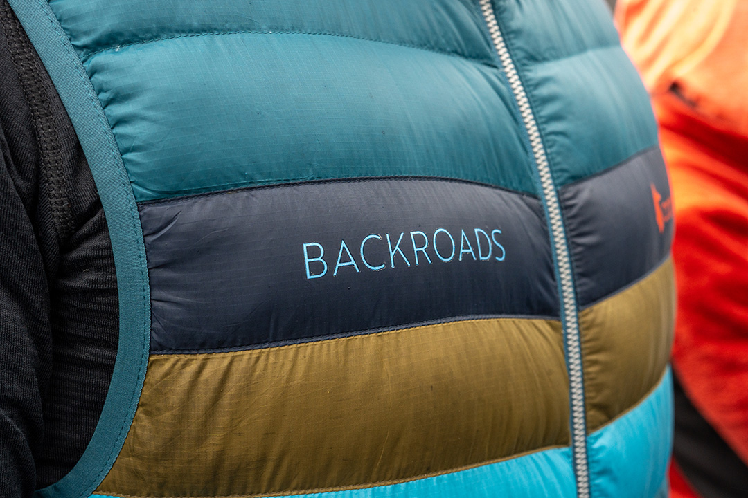 Backroads branded puffer vest in blue and brown