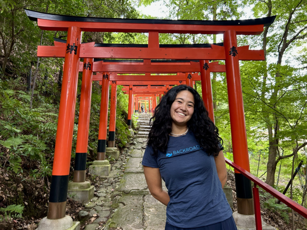 Image of a trip prep specialist in front of a series of torii in Japan.