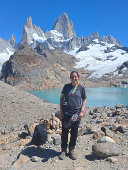 Trip prep specialist standing in front of a glacial lake in Patagonia.
