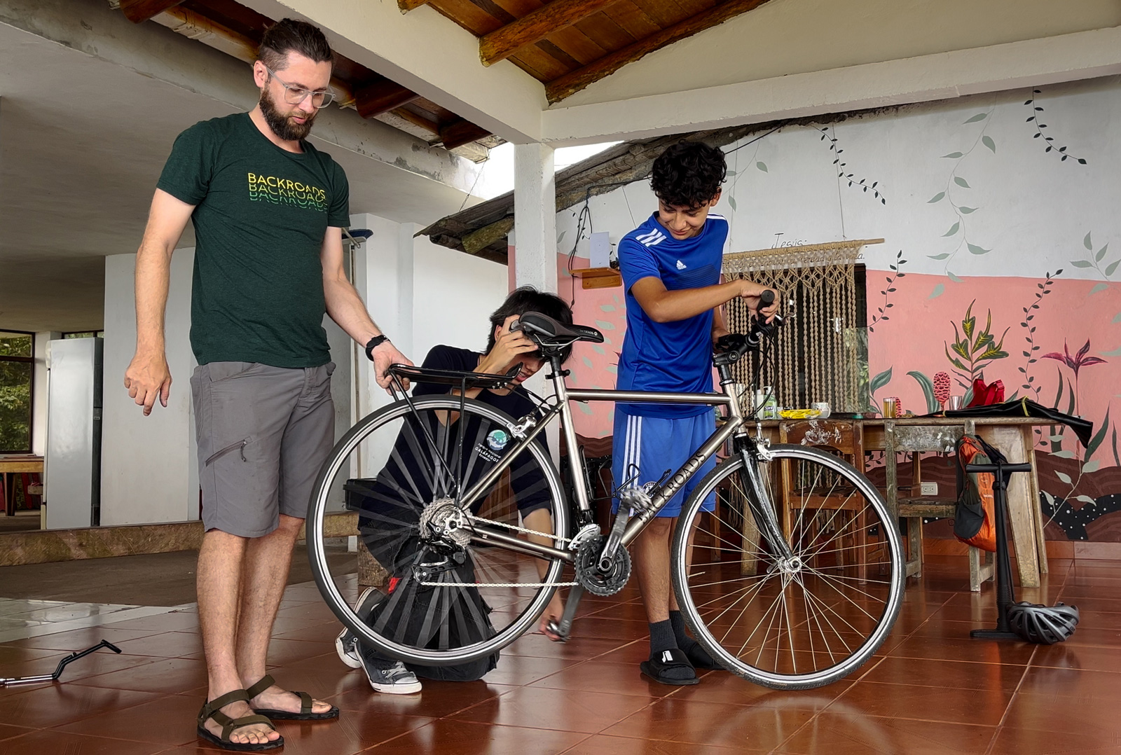 Man showing a bike to a younger child