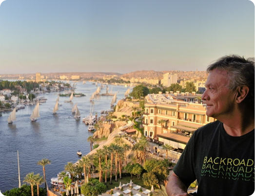 Man in a backgroads shirt looks out over the Nile River.