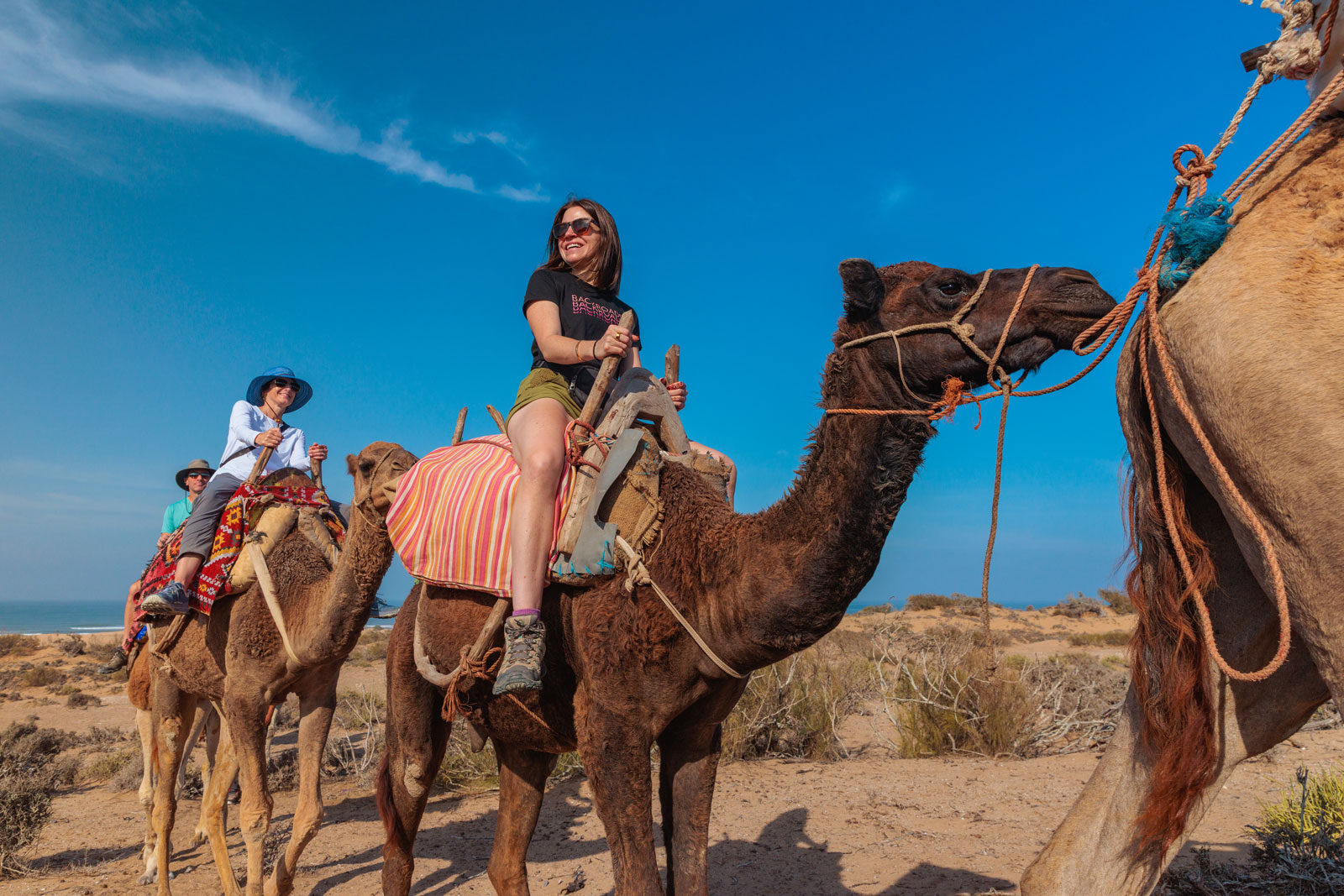 Woman riding on top of a camel