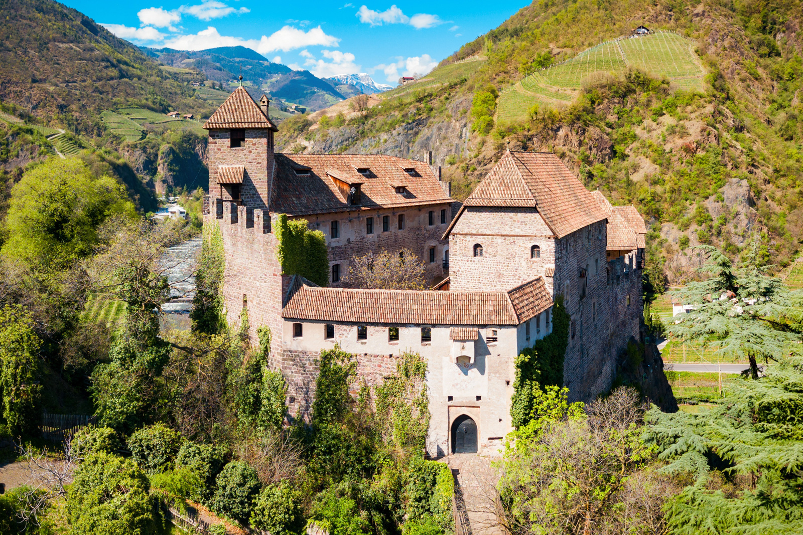 Exterior view of a castle-like building in the middle of a valley