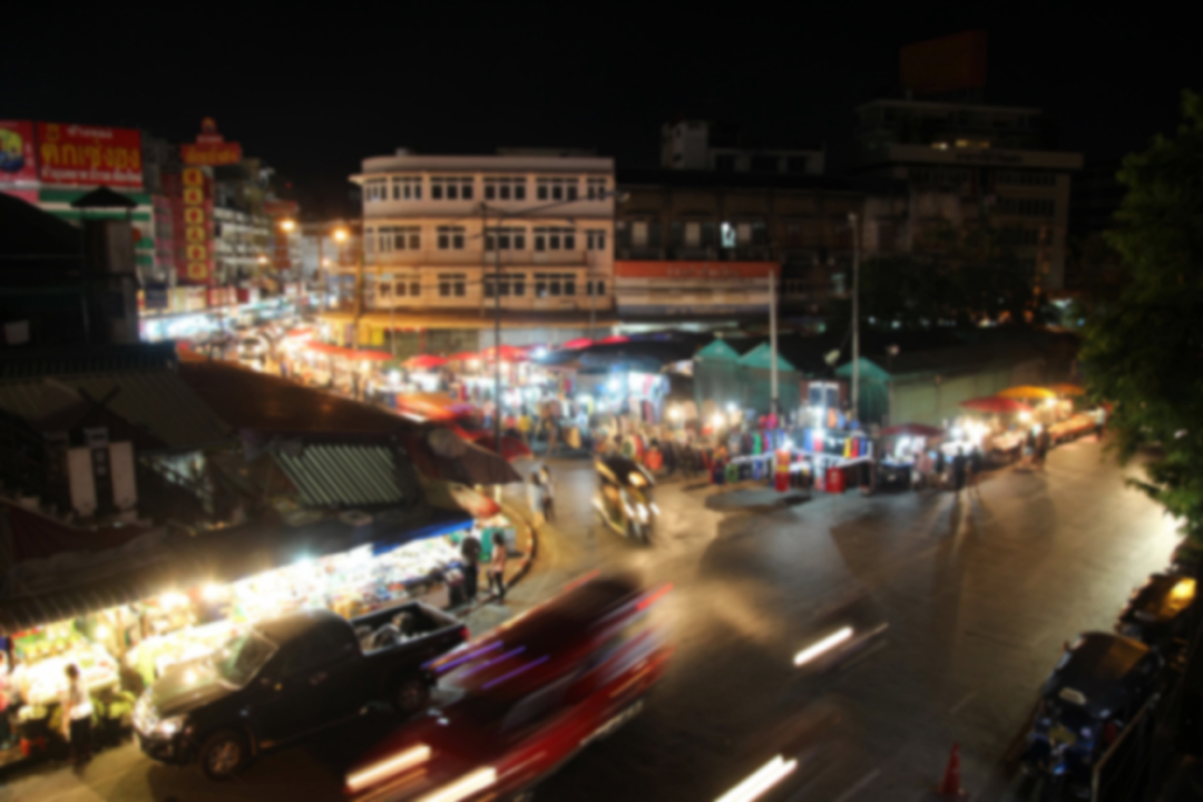 Evening view of a street intersections with blurry cars and motorcycles