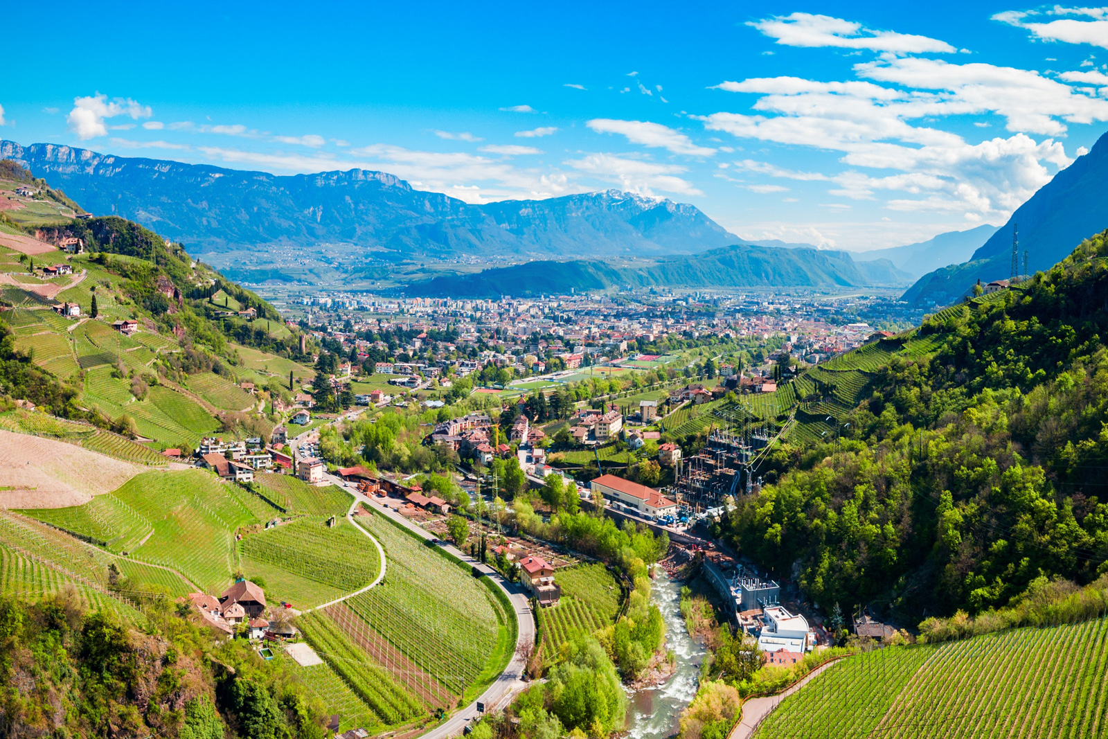 Sky view of valley with a small town in a grassy valley