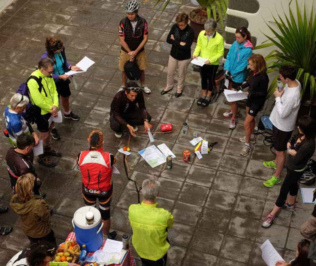 A Backroads leader gives the days instructions to guests on a bicycling tour