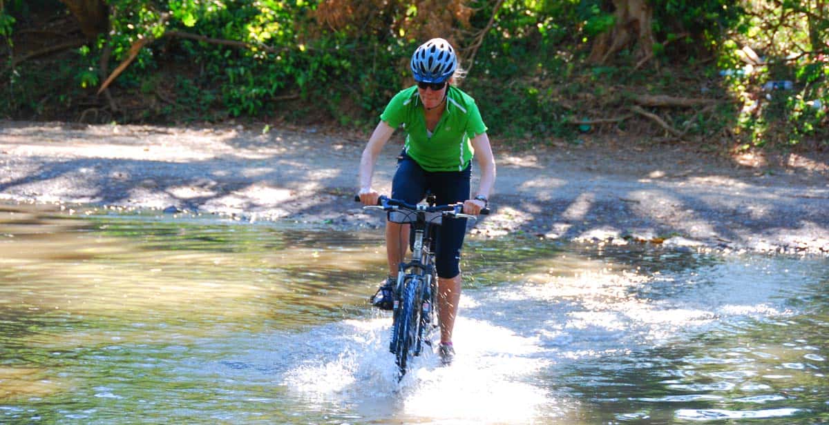 Mountain bike crossing a stream in Belize