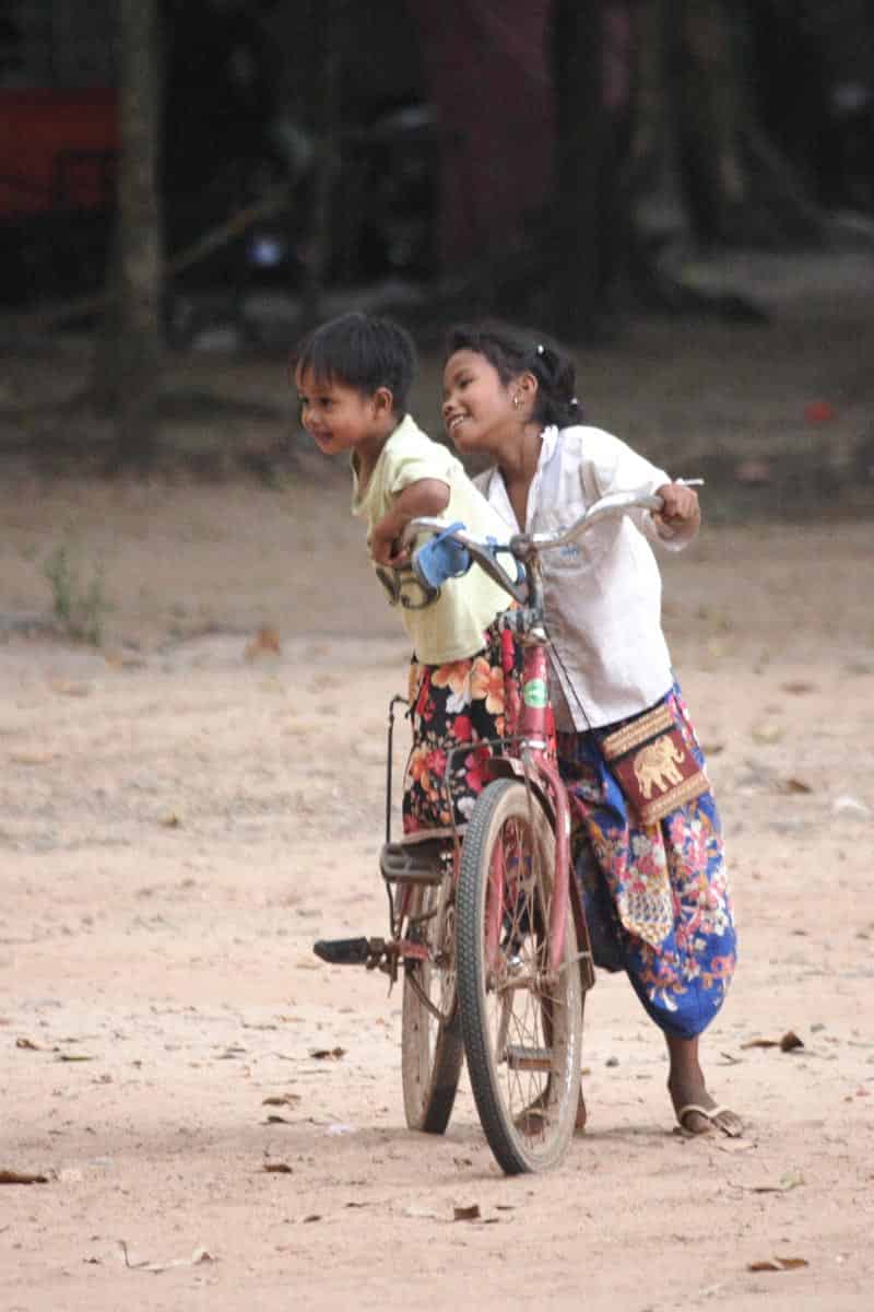 Vietnam and Cambodia local children riding a bike.