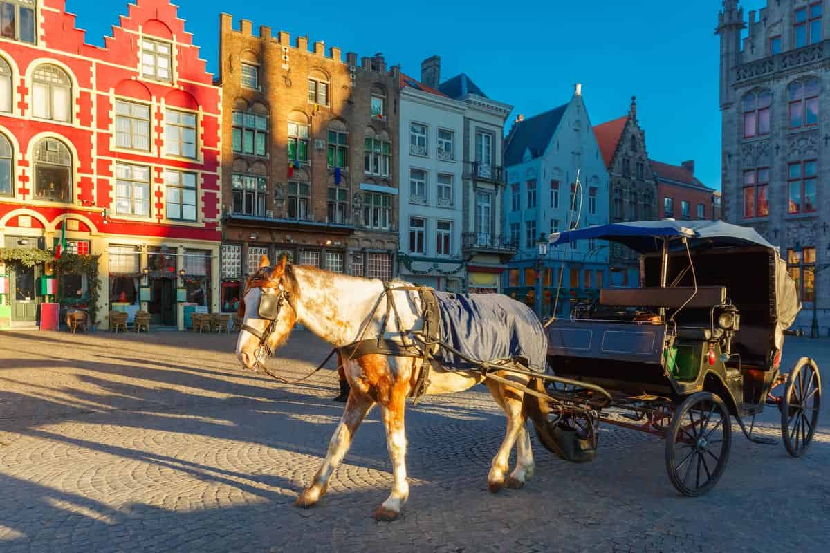 Bruges Belgium cobblestone strett and horse carriage