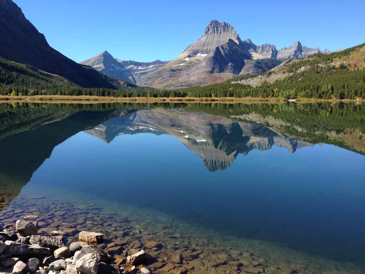 Mountains reflecting on Swiftcurrent Lake in Glacier National Park
