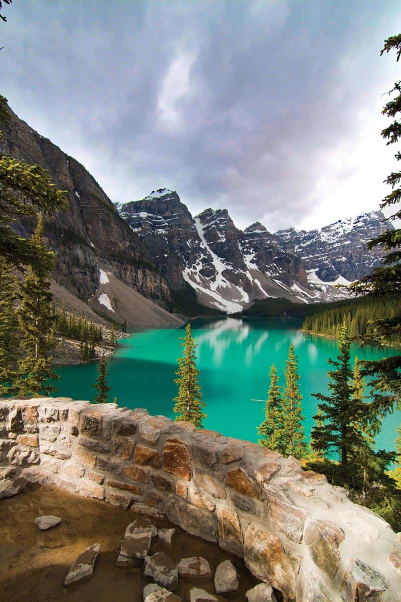 Lake Louise lookout point with green lake and snow-capped mountains in the Canadian Rockies
